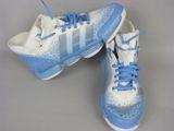 pair of white and blue tennis shoes with blue laces on them