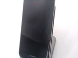 a cell phone that is sitting on top of a stand