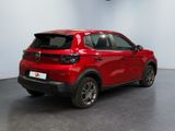the rear end of a red car parked in a garage
