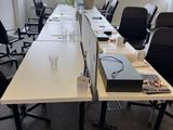 a long table with a laptop on it in an office