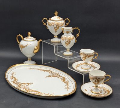 a white and gold table setting with a tray and cups