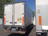two trucks that are parked in a parking lot