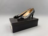 a pair of black shoes sitting on top of a black box