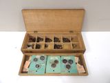 a wooden box that has a bunch of coins inside of it