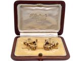 two pairs of cufflinks in a case on a white background