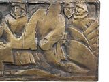 an image of a bronze plaque depicting a group of people sitting on a bench
