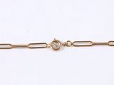 a close up of a gold chain with a clasp on a white background
