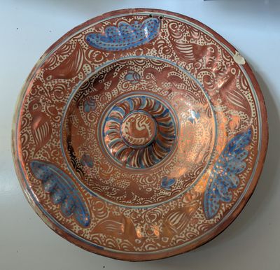 an image of a brown and blue plate sitting on top of a table