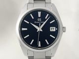 a close up of a wrist watch with a blue dial