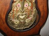 a wooden clock with a floral design on it
