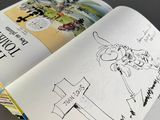 an open book with a drawing of a woman on it