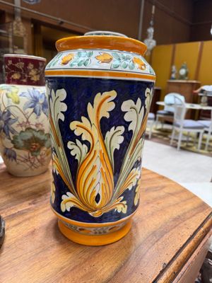a vase sitting on a table with other vases in the background