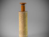 a small wooden bottle with a wooden cap on top of it
