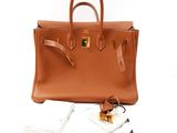 an image of a brown leather handbag with a tag on it