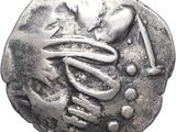a close up of a silver coin with a snake on it