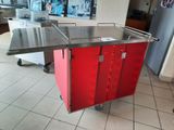 a red cart that is sitting in the middle of the floor