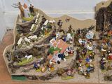 many figurines of people and animals on the table