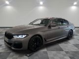 the bmw m5 competition wagon is parked on a checkered floor