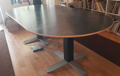 an image of a table in a room with bookshelves in the background