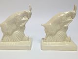 pair of white ceramic fish bookends on a white background