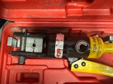 a tool in a red case with a yellow handle
