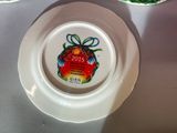 a plate with a christmas ornament on it next to a plate with a christmas ornament on it