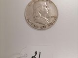 a close up of a coin on a white surface with a price tag
