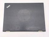 the back cover of a laptop with a small hole in it