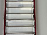 a red and white tray with a bunch of metal items in it