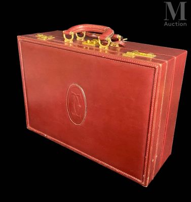 a red suitcase with gold handles on a black background