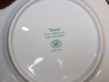a white plate with a green quote on it