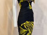 the mannequin is wearing a black and yellow dress with yellow flowers