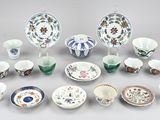 many different types of dishes and cups on the table
