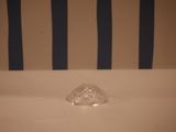 a small clear object sitting on a white table