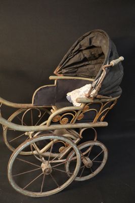 a baby carriage with a baby in it on a black background