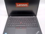 a black laptop with a red lenovo logo on the screen