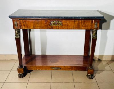 a small table with a marble top on wheels