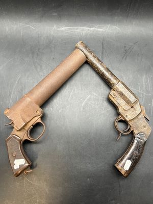 two old guns that are on a metal surface