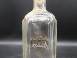 an old glass bottle with a stopper sitting on top of a table