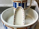 two cups that are sitting in a bowl on the counter