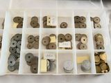 many different types of coins in a plastic box