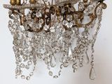 a chandelier hanging from the ceiling with a bunch of crystal beads