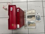 a red case that is sitting on a tiled floor