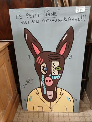 a sign with a picture of a donkey with a face painted on it