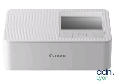 un gros plan d'une imprimante Canon posée sur une table blanche