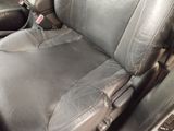 a picture of a car seat with a dirty seat cover