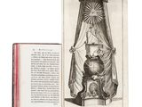 an open book with a picture of a crown on top of it