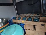 many bowls and pans in the back of a truck
