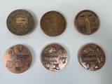 four different types of coins are shown on a white surface