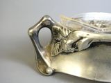a silver plate with a spoon and a bowl on it